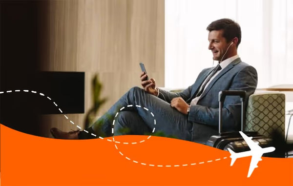 Business traveller relaxing in an airport lounge using his phone with a SimYak eSIM