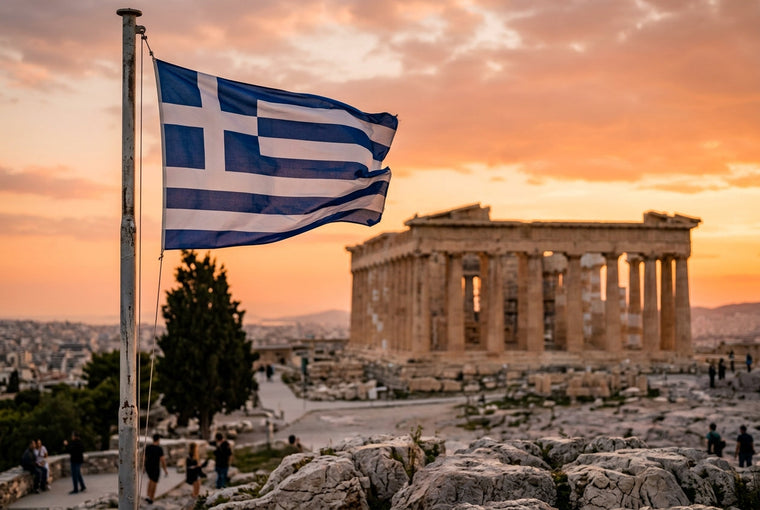 Greek flag flying above the Acropolis of Athens at golden hour with the Parthenon temple