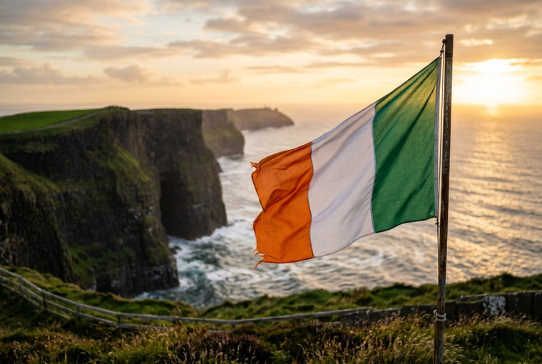 Irish tricolour flying above the Cliffs of Moher at golden hour